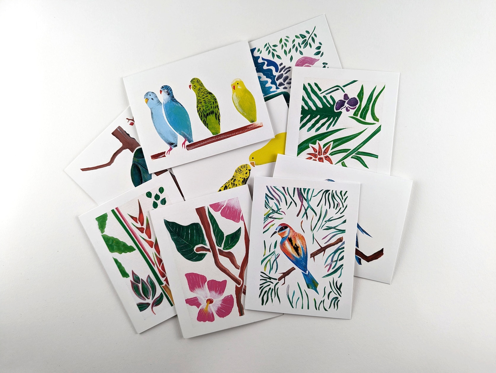 Set of 9 cards colourful painted cards. Each card features a tropical bird or flower.