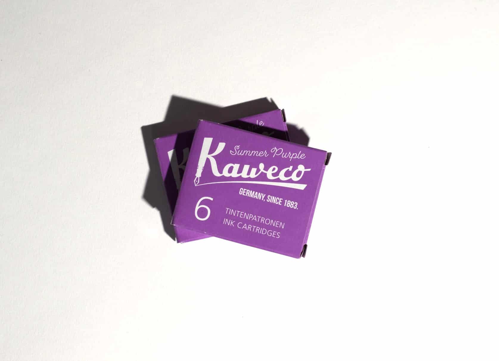 Two boxes of ink cartridges lie on a white surface. Text on packaging reads: Kaweco. Summer Purple. Germany, since 1883. 6 Tintenpatronen. Ink Cartridges.