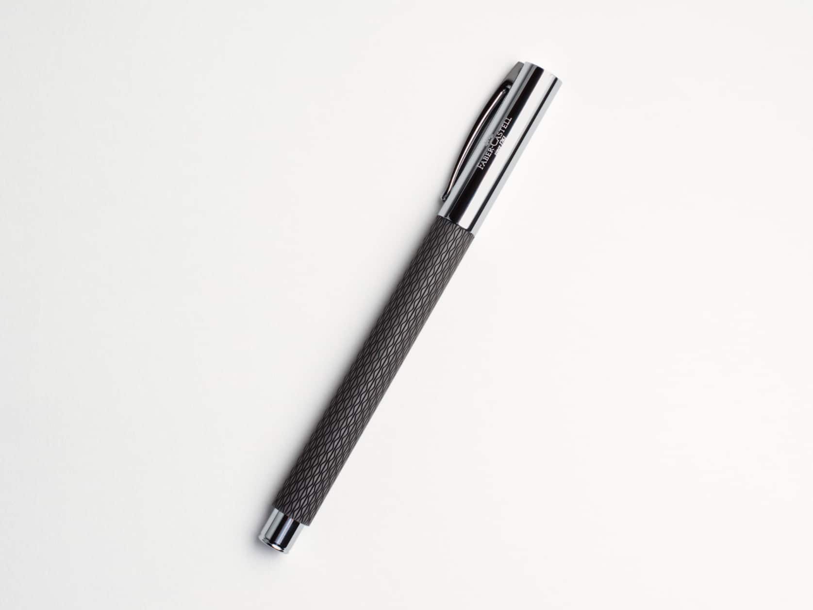 Black fountain pen with a textured body and a shiny metal cap and end. Cap has Faber-Castell logo.