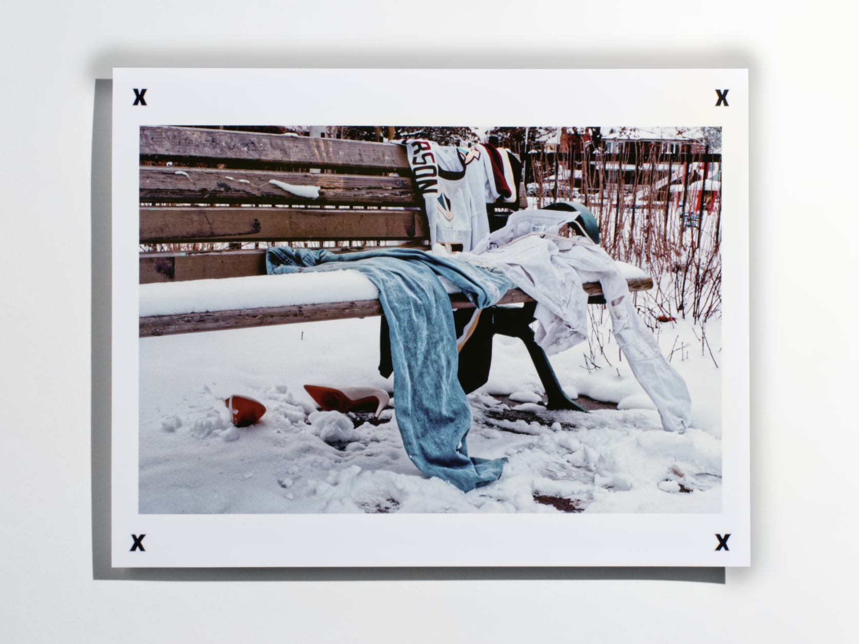 Photograph print of clothes left on a bench outisde in the snow