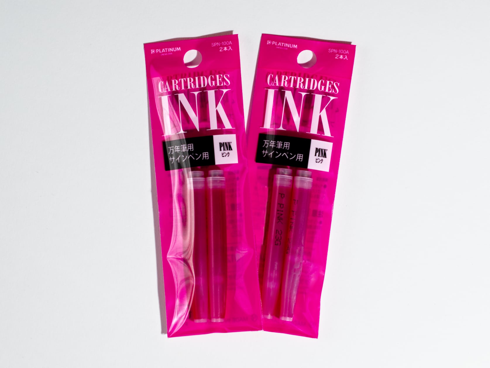 Two pink packs each containing two pink ink cartridges. Text on packs reads: CARTRIDGES INK, Pink.